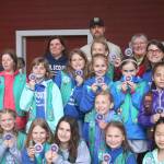 The ladies of Girl Scout Troop 42130 out of Cascade Ridge Elementary School in Sammamish hold up their brand-new kokanee patches, earned for their service projects to help save the little red fish. Nicole Jennings/staff photo