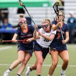Photo courtesy of Rick Edelman/Rick Edelman Photography                                Eastside Catholic players Carlin Reilly, left, and Olivia Jacobsen, right, put pressure on Bainbridge Island midfielder Kiera Havill during the state championship game on May 19 in Tukwila. Eastside Catholic defeated Bainbridge Island 16-11.