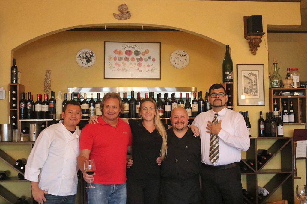 At Firenze Ristorante, everyone is a family. From left, cook Jose Alvarez, owner Sal Lembo, his daughter Valentina, cook Francis Vidal and server David Soto. Nicole Jennings/staff photo