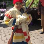 Lucas, age 7 from the Issaquah Highlands, tries on the trappings of an 1820s Hudson&rsquo;s Bay Company French voyageur at the Cascade Mountain Men booth. William Shaw/staff photo