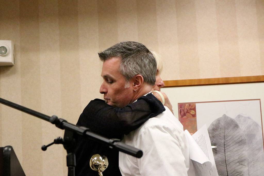 Jerry Blackburn hugs Jody Mull of the Issaquah Schools Foundation as he receives the foundation&rsquo;s Golden Apple Award. Nicole Jennings/staff photo