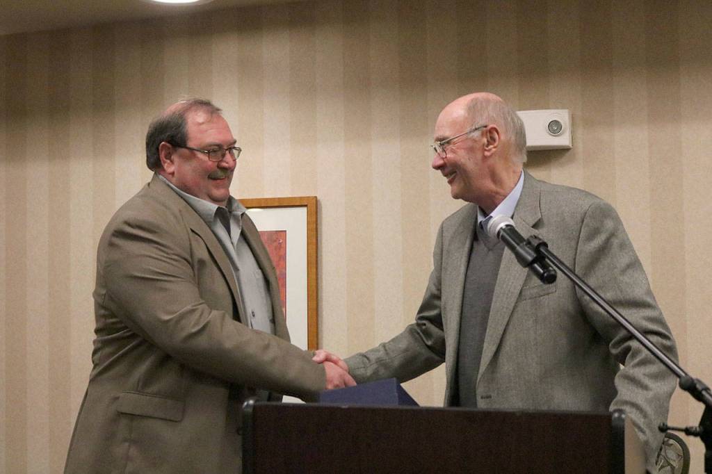 Issaquah Mayor Fred Butler welcomes Joe Forkner into the city&rsquo;s Hall of Fame with a hearty handshake. Nicole Jennings/staff photo