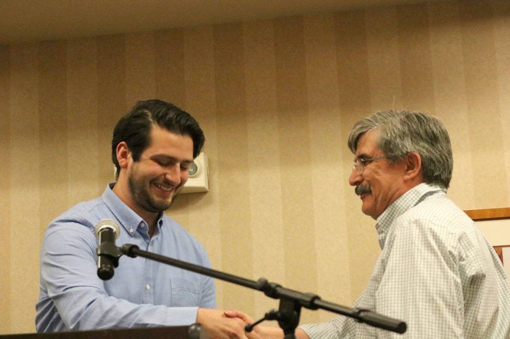 Issaquah Parks and Recreation Specialist Cameron Roth, left, gives George Whitehouse, right, the Sportsperson of the Year Award from the Issaquah Park Board. Carrie Rodriguez/staff photo