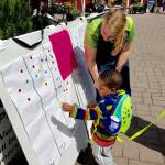 A young Farmers Market shopper takes part in the Parks Department survey. William Shaw/staff photo