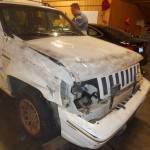 Trooper Rick Johnson examines the Jeep, pointing out where fingerprint samples were taken for testing. Nicole Jennings/staff photo