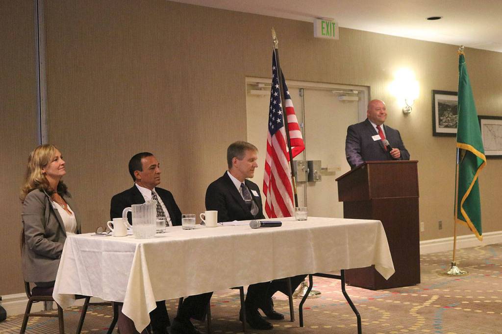 At the podium, Chamber Board President David Bleiwiess introduces the three candidates. Nicole Jennings/staff photo