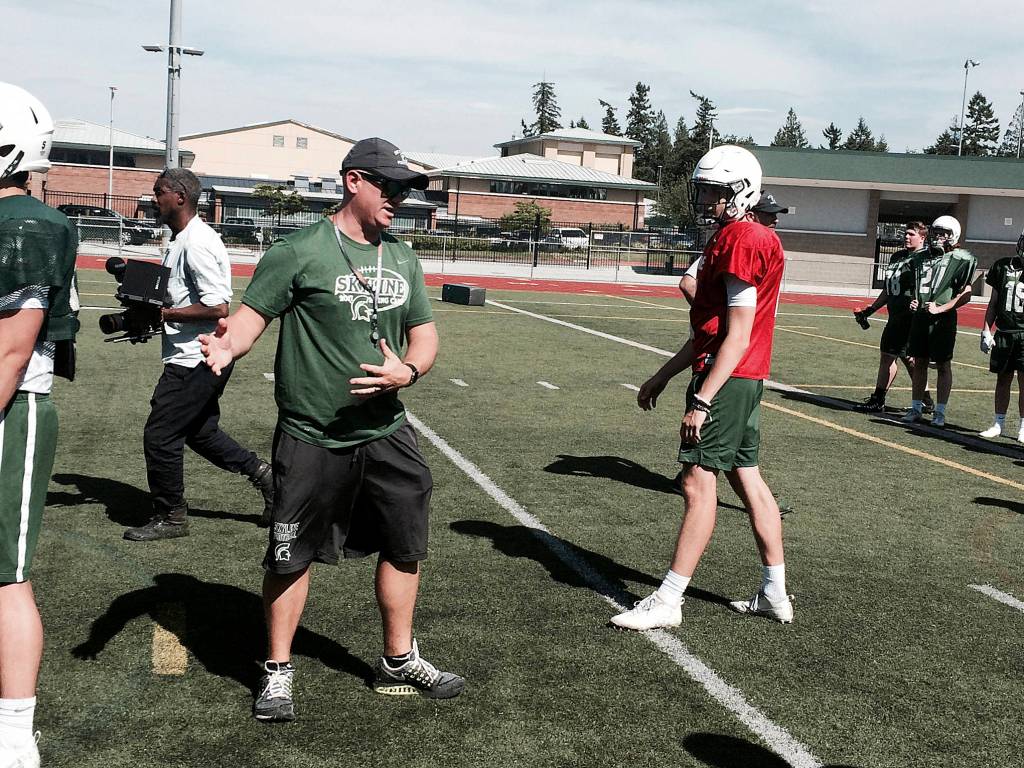 Shaun Scott/staff photo                                Skyline Spartans Mat Taylor instructs a player on the fundamentals of the game during the fourth spring football practice on June 6. Taylor was presented with the Gatorade Coaching Excellence Award on June 5 at Skyline High School. The award, which is given out to just two coaches throughout the U.S. per year, honors the best and most dedicated high school coaches across the country.