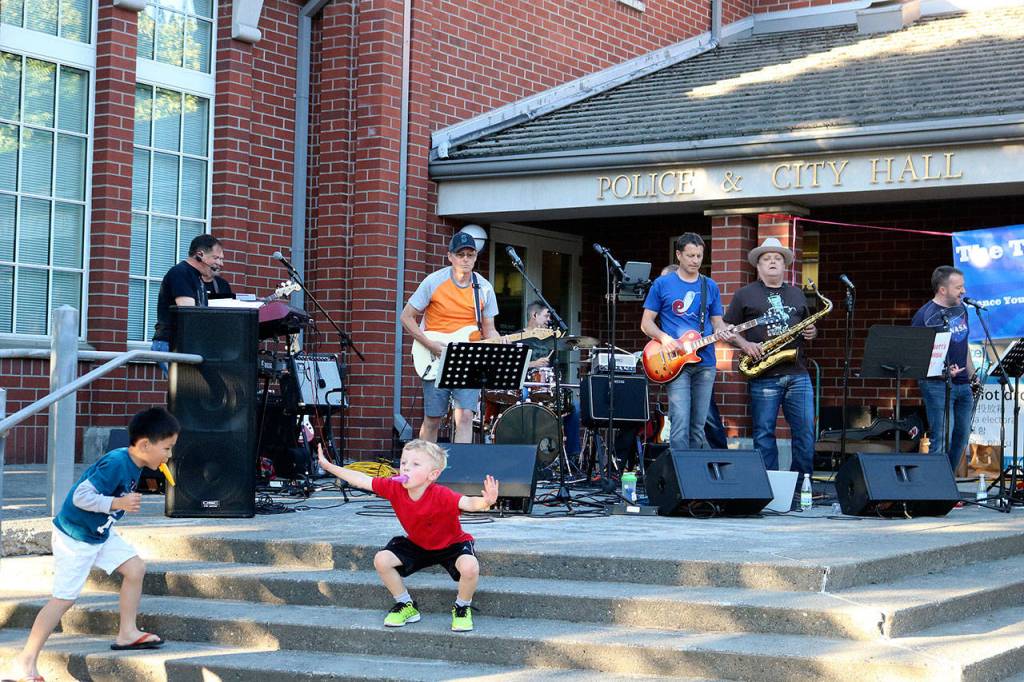 Issaquah rock n&rsquo; roll band The Tasty Waves brought classic hits of the &rsquo;70s, such as Steely Dan&rsquo;s &ldquo;Old School&rdquo; to the steps of City Hall as youngsters joined in with their dance moves. Nicole Jennings/staff photo