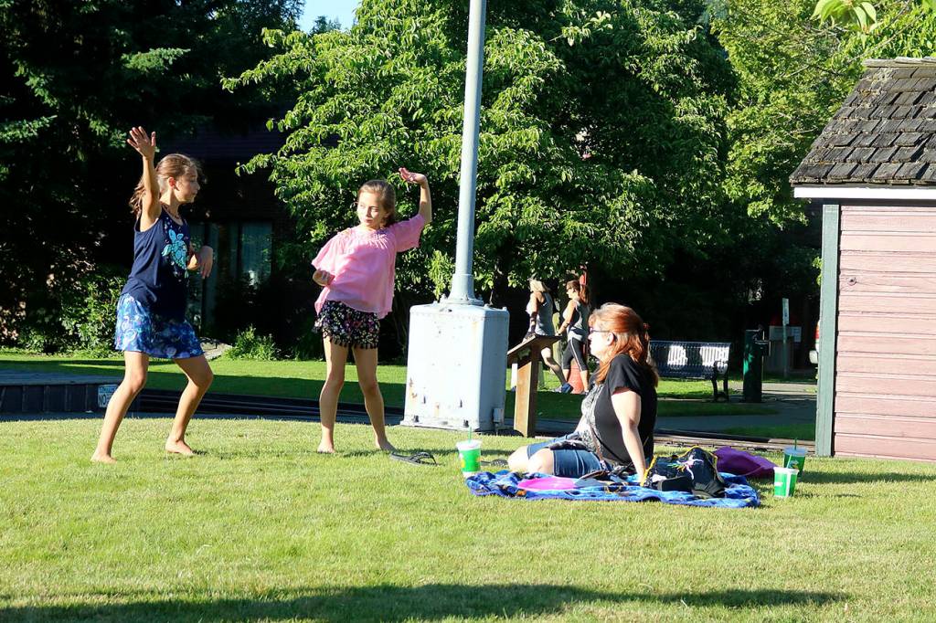 Enjoying the first evening of sun in 10 days, girls happily danced to the music on the grass outside the Historic Train Depot. Nicole Jennings/staff photo