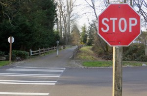 The southern segment of the East Lake Sammamish Trail at 206th Avenue Southeast before construction began. Here the county wants to relocate these stop signs so trail users can have the right of way. Megan Campbell/staff photo