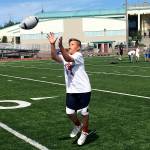Shaun Scott/staff photo                                Seventh grader Brayden Mohamed hauls in a pass during a pass receiving drill during the first day of the Eastlake Wolves True Champions youth football camp on July 17 at Eastlake High School in Sammamish.