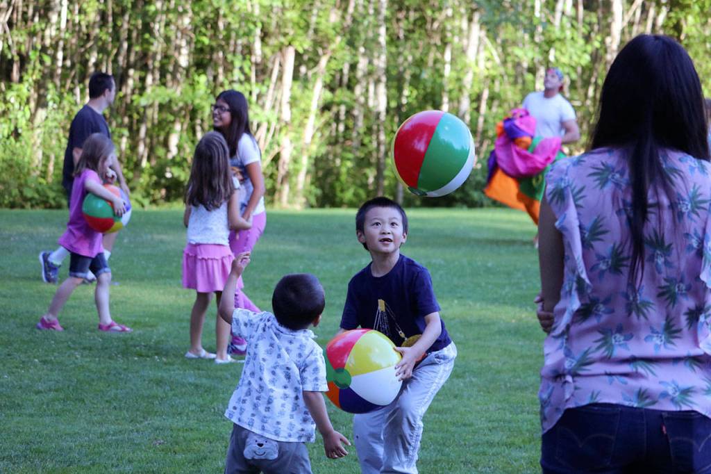 Brothers Yan, 5, and Derek Xu, 2, play with bouncy balls at the Sammamish Concerts in the Park July 13. Megan Campbell/staff photo