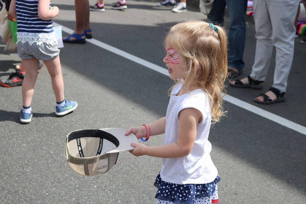 Kids used baseball caps and bags to collect the multitude of candy thrown by parade participants. Nicole Jennings/staff photo
