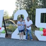 Maria, Lupita, and Silvestre Monroy stand by the large 125th birthday sign at Confluence Park. (Evan Pappas/Staff Photo)