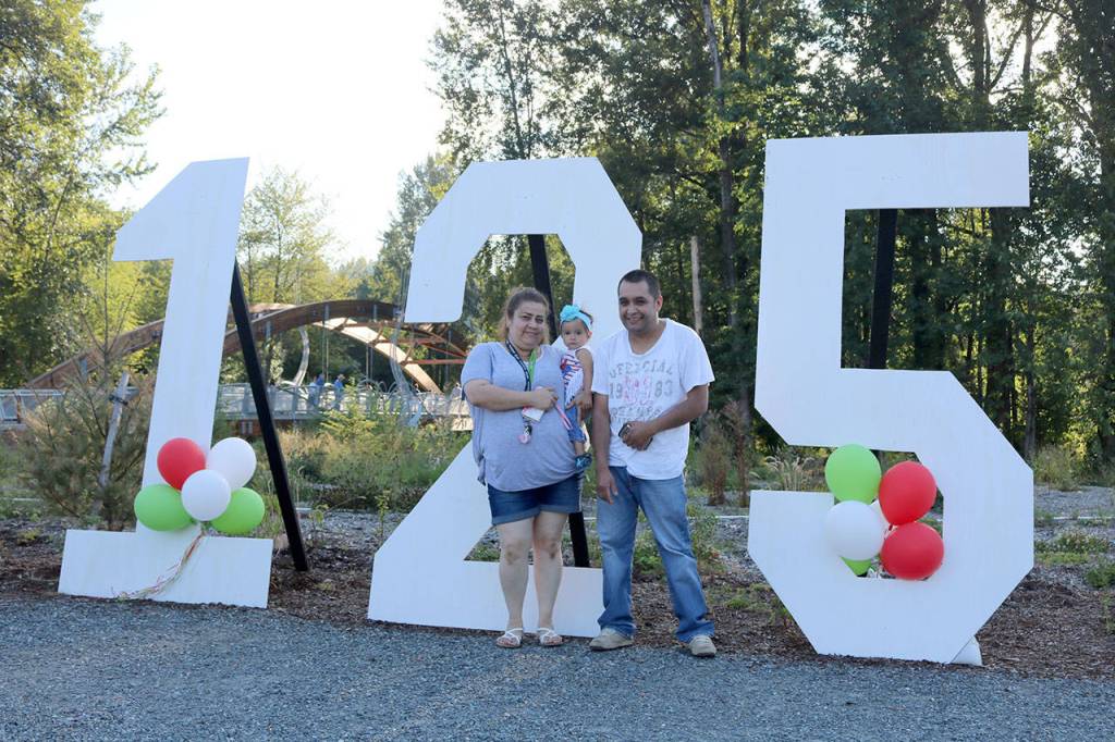 Maria, Lupita, and Silvestre Monroy stand by the large 125th birthday sign at Confluence Park. (Evan Pappas/Staff Photo)