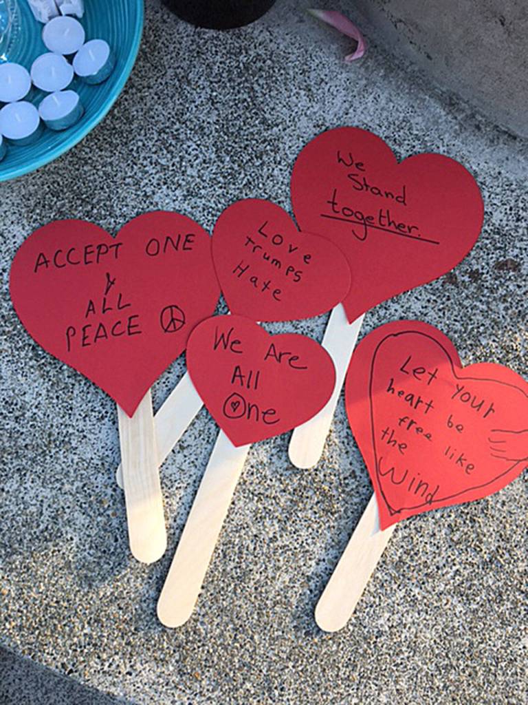 The Plateaupians created these signs of love at the vigil. Photo courtesy of Plateaupians for Peace