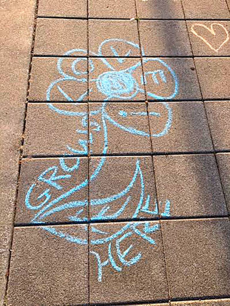 Attendees of the Sammamish vigil wrote messages of love and peace in chalk outside Sammamish City Hall. Photo courtesy of Plateaupians for Peace