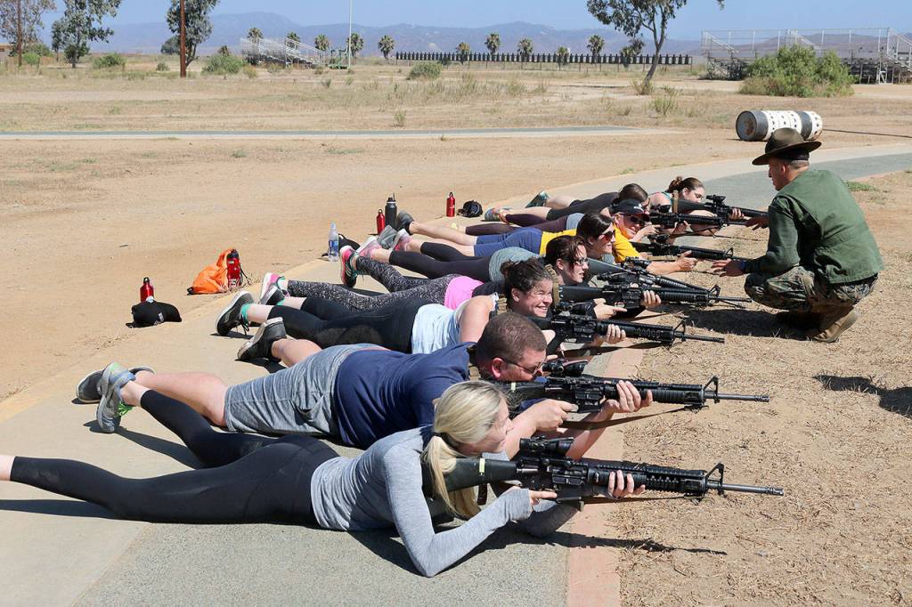 The teachers get comfortable handling unloaded M16 assault rifles. Nicole Jennings/staff photo