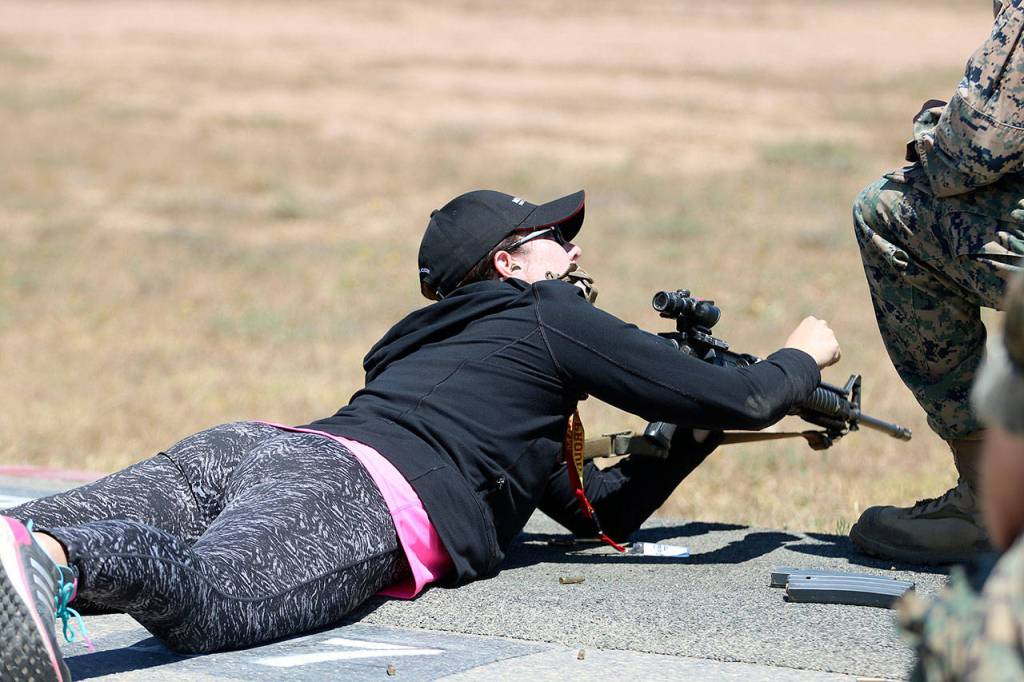 Kelly McLaurin, who teaches Spanish and ELL at Inglemoor High in Kenmore, gets comfortable handling an M16. Nicole Jennings/staff photo