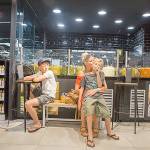 From left, Finn, Mindi and Jens (on Mindi&rsquo;s lap) take refuge in a Carrefour grocery store after the terrorist attack on Las Ramblas. Photo courtesy of Kronstad family