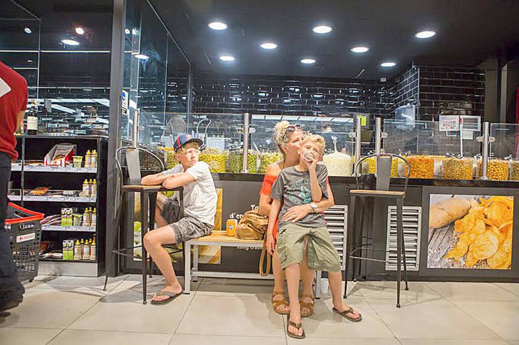 From left, Finn, Mindi and Jens (on Mindi&rsquo;s lap) take refuge in a Carrefour grocery store after the terrorist attack on Las Ramblas. Photo courtesy of Kronstad family