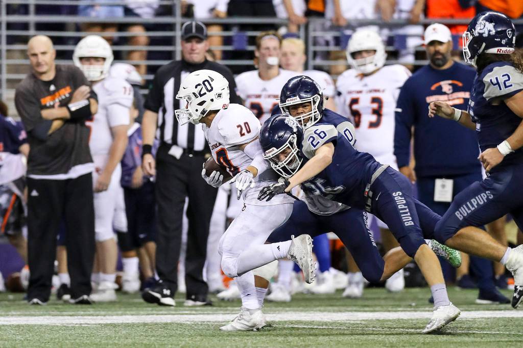 Photo courtesy of Rick Edelman/Rick Edelman Photography                                 Eastside Catholic running back Giovanni Ursino rumbles for a large again against the Gonzaga Prep Bullpups on Sept. 2 at Husky Stadium in Seattle. The Crusaders defeated the Bullpups 41-40 in triple overtime.