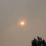 The smoke-filled sky has taken on an eerie color, as seen in this photograph taken from Bellevue Tuesday morning. Nicole Jennings/staff photo