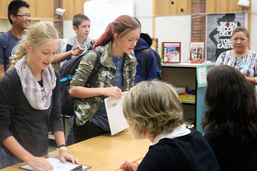 Student immigrants attempt to answer legal questions, such as why they came to America and if they have jobs awaiting them; the entire process is conducted in German. Nicole Jennings/staff photo