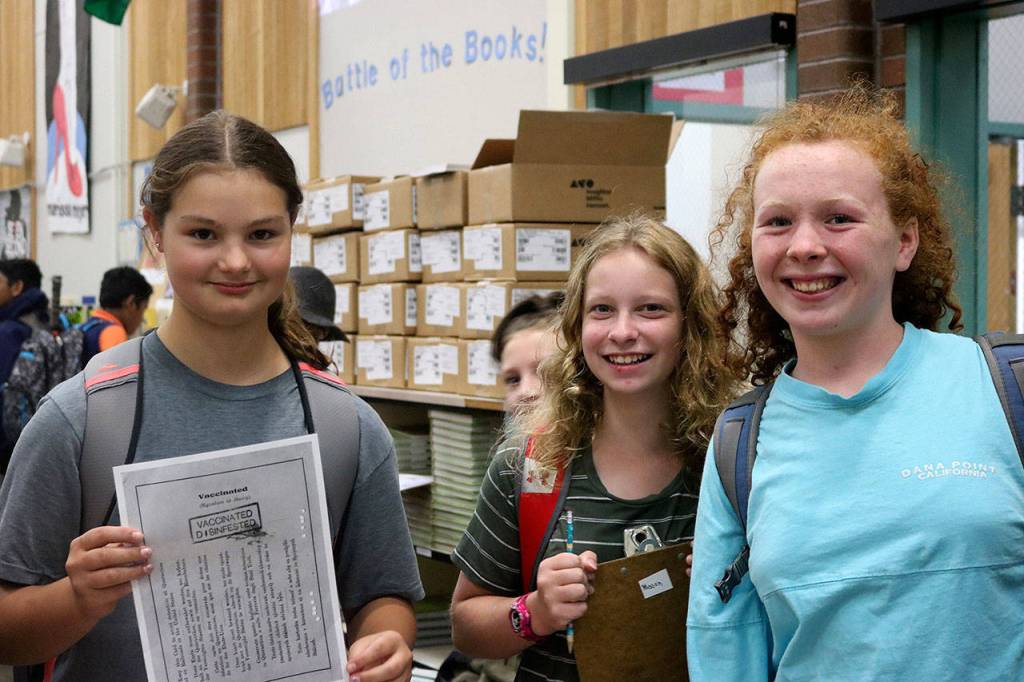 Students in quarantine show thier vaccination papers, proving they are free of smallpox. Nicole Jennings/staff photo