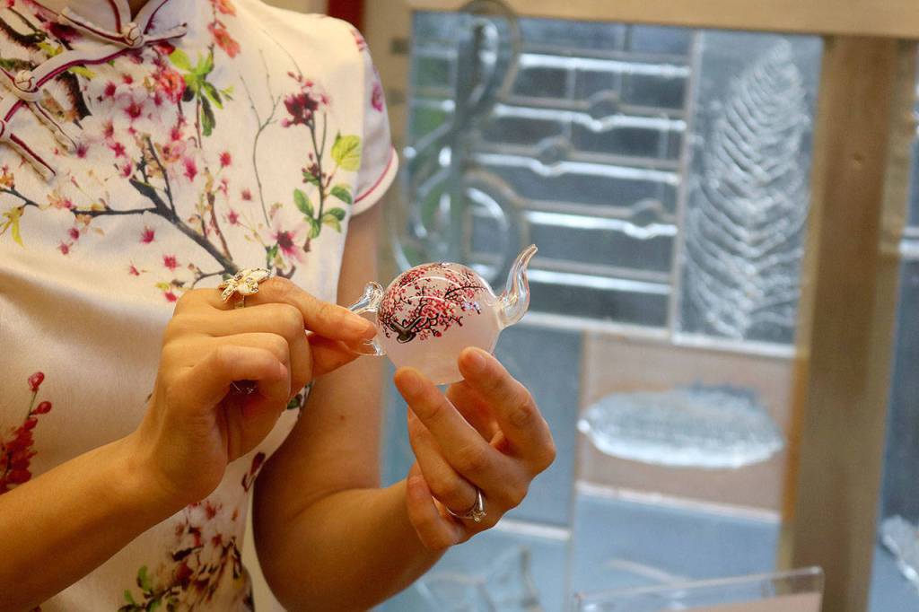 Inner painting, shown up-close by Partlow, is a Chinese style of art in which intricate designs on snuff bottles are painted from the inside. Nicole Jennings/staff photo