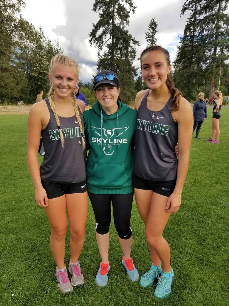 Photo courtesy of Susan Schlepp                                The Skyline Spartans girls Cross Country team captured a victory in a KingCo 4A double dual meet against Inglemoor and North Creek on Sept. 20 at North Creek High School in Bothell. The Spartans improved their KingCo dual meet record to 4-0 with the victory. Geneva Schlepp finished in first place on the 5K course (3.2 miles) with a time of 18 minutes, 32 seconds. Skyline junior Brooke Harmer captured second place with a time of 20:34. Amber McGraw earned a fourth place finish (20:45), freshman Lauren Holford collected a fifth place showing with a time of 20:53 and Mary Webb attained an eighth place finish. McGraw, Skyline girls coach Chelsea VanDeBrake and Schlepp are pictured in the above photo.
