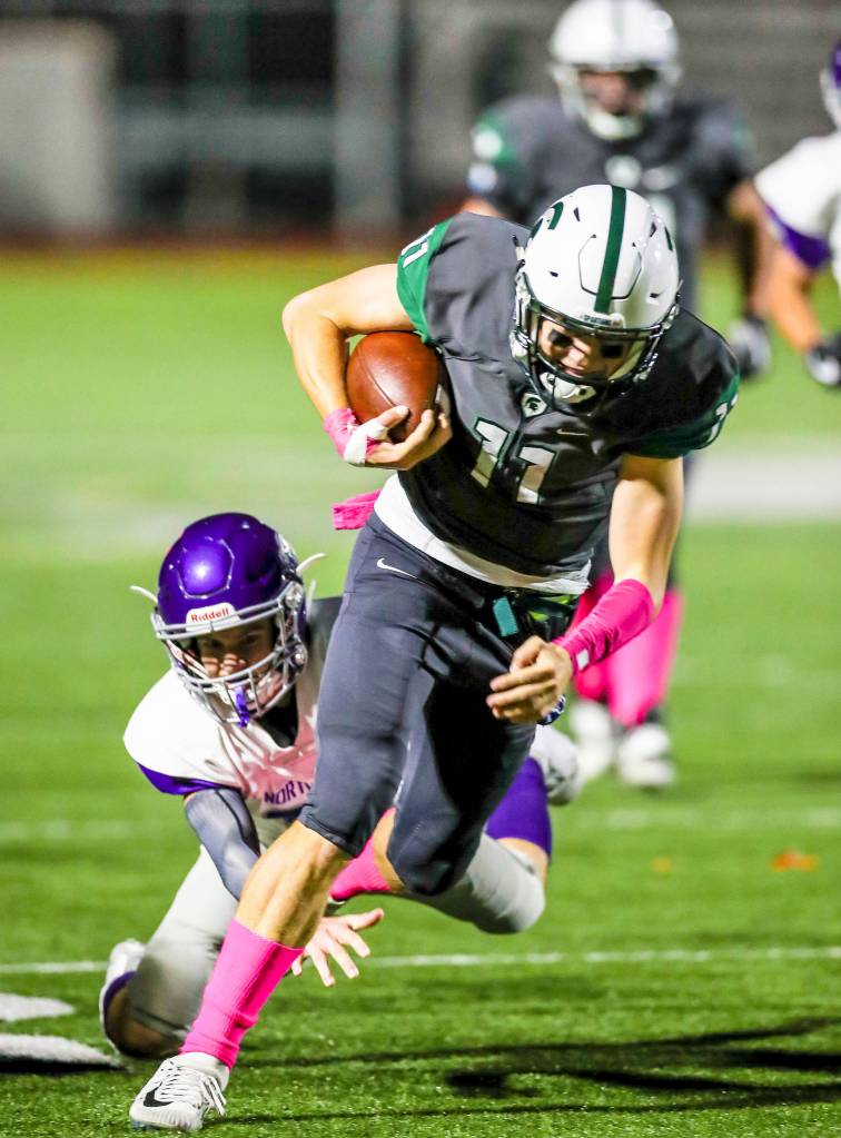 Photo courtesy of Rick Edelman/Rick Edelman Photography                                The Skyline Spartans cruised to a 41-0 victory against the North Creek Jaguars on Sept. 29 in Sammamish. The Spartans improved their overall record to 3-2 with the win. Skyline quarterback Joe Green, pictured, scrambles for yardage against North Creek. The Spartans will face the Eastlake Wolves in a KingCo 4A matchup between schools separated by just 1.2 miles at 7 p.m. on Oct. 6 in Sammamish.