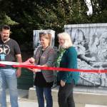 Hals, center, cuts the ribbon in front of her work of art, while her husband Ivar Karvatn, left, and Sister Cities Commissioner Robin Kelley, right, look on. Nicole Jennings/staff photo