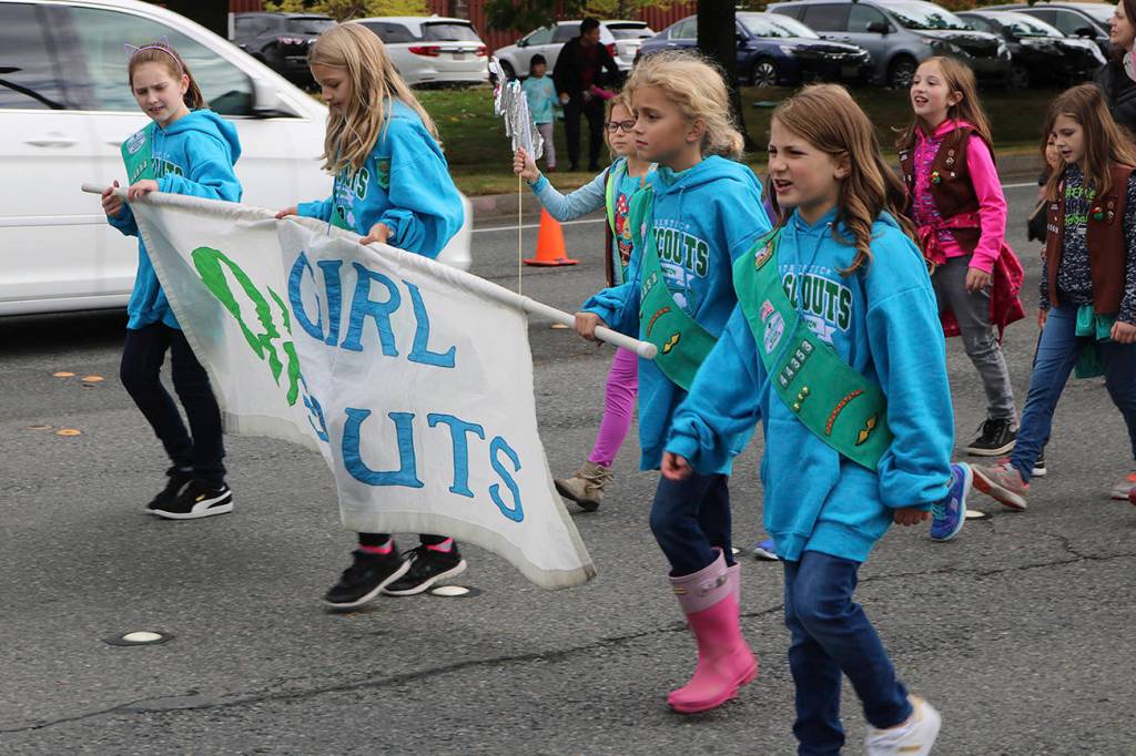 Local Girl Scouts proudly carry their flag. Nicole Jennings/staff photo