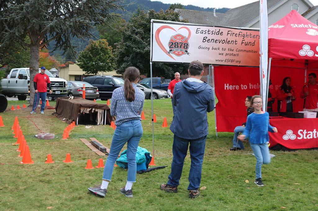 Kids run through the obstacle course at the Eastside Fire and Rescue tent. Nicole Jennings/staff photo