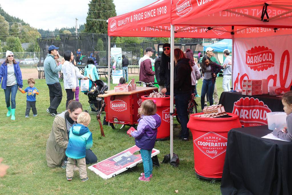 Youngsters toss beanbags at Darigold&rsquo;s tent in the Field of Fun. Nicole Jennings/staff photo