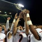 Shaun Scott, staff photo                                The Eastside Catholic Crusaders football team hoists the Metro League championship trophy following their 49-6 victory against the Roosevelt Roughriders on Oct. 20 at Memorial Stadium in Seattle. The Crusaders finished the 2017 regular season with an overall record of 8-0.