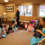 Tracy Willis read a Halloween-themed story to an audience of Princess Elsa&rsquo;s and Spidermen. Nicole Jennings/staff photo