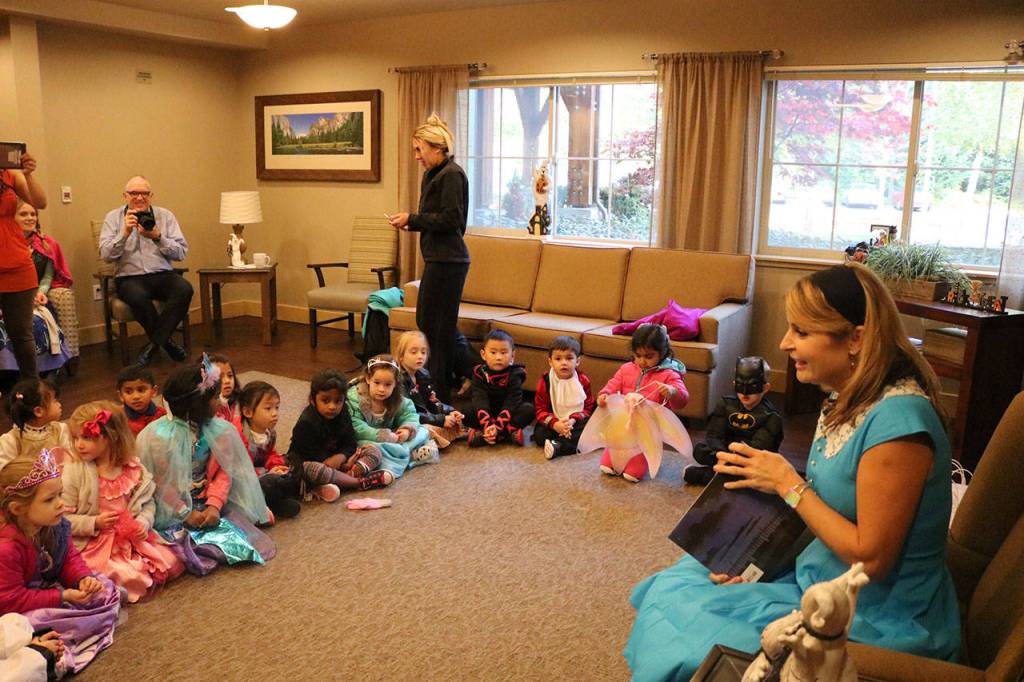 Tracy Willis read a Halloween-themed story to an audience of Princess Elsa&rsquo;s and Spidermen. Nicole Jennings/staff photo