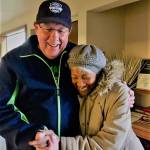 An Old Friends Club member gets a hug from a community member. Photo courtesy of Old Friends Club