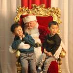 Yuta and Sota Hidaka get a picture with Santa Claus. (Evan Pappas/Staff Photo)
