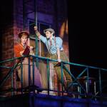 Katherine Plumber (Taylor Niemeyer) writes a theatre review as head Newsie Jack Kelly (Joey Barreiro) attempts to flirt with her. Katherine later uses the power of the pen to draw attention to the Newsies strike. Photo courtesy of Village Theatre