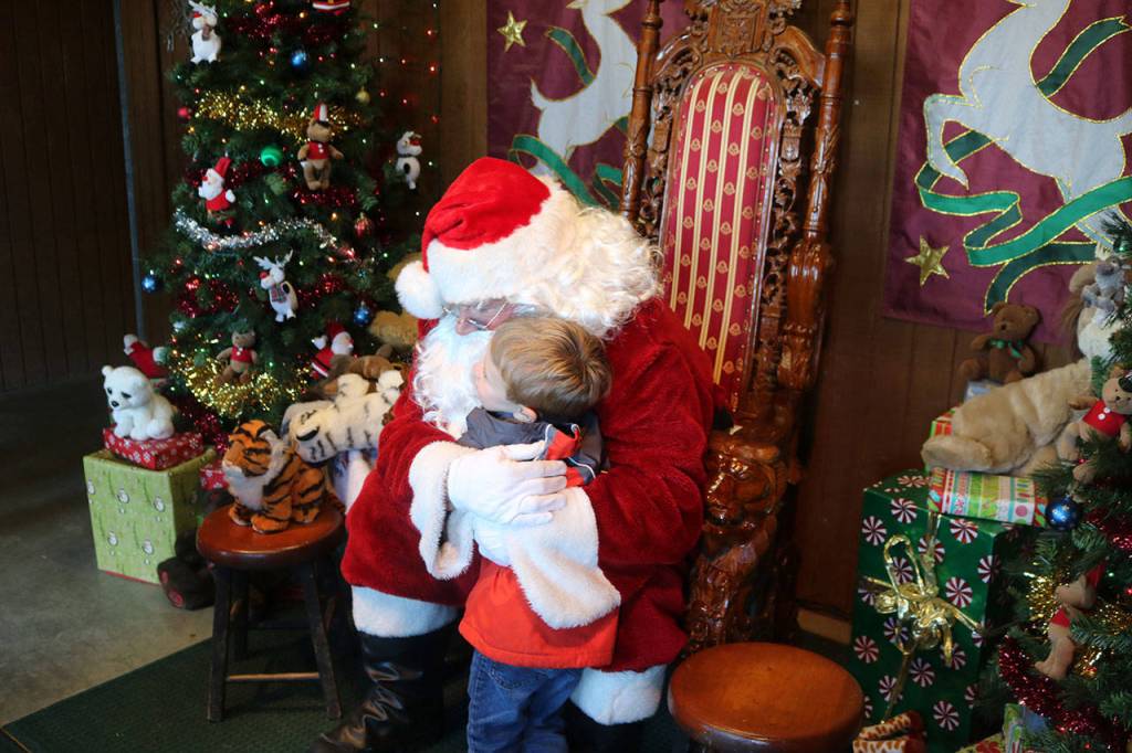 Santa receives a hug from Reid Felczak, 4. Nicole Jennings/staff photo