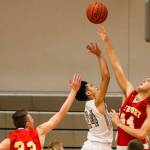 Photo courtesy of Rick Edelman/Rick Edelman Photography                                The Newport Knights boys basketball team defeated the Skyline Spartans 57-55 in a close game between KingCo 4A rivals on Dec. 15 at Skyline High School in Sammamish. The Spartans dropped to 5-3 overall with the loss. Skyline senior guard Sean Wright (pictured) leaped into the air to try to grab a rebound from Newport post player Alexander Tzekov.