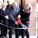 Outgoing Mayor Fred Butler and Candy Mache owner Brenda Zylstra cut the candy ribbon to mark the official opening of the business. Courtesy photo