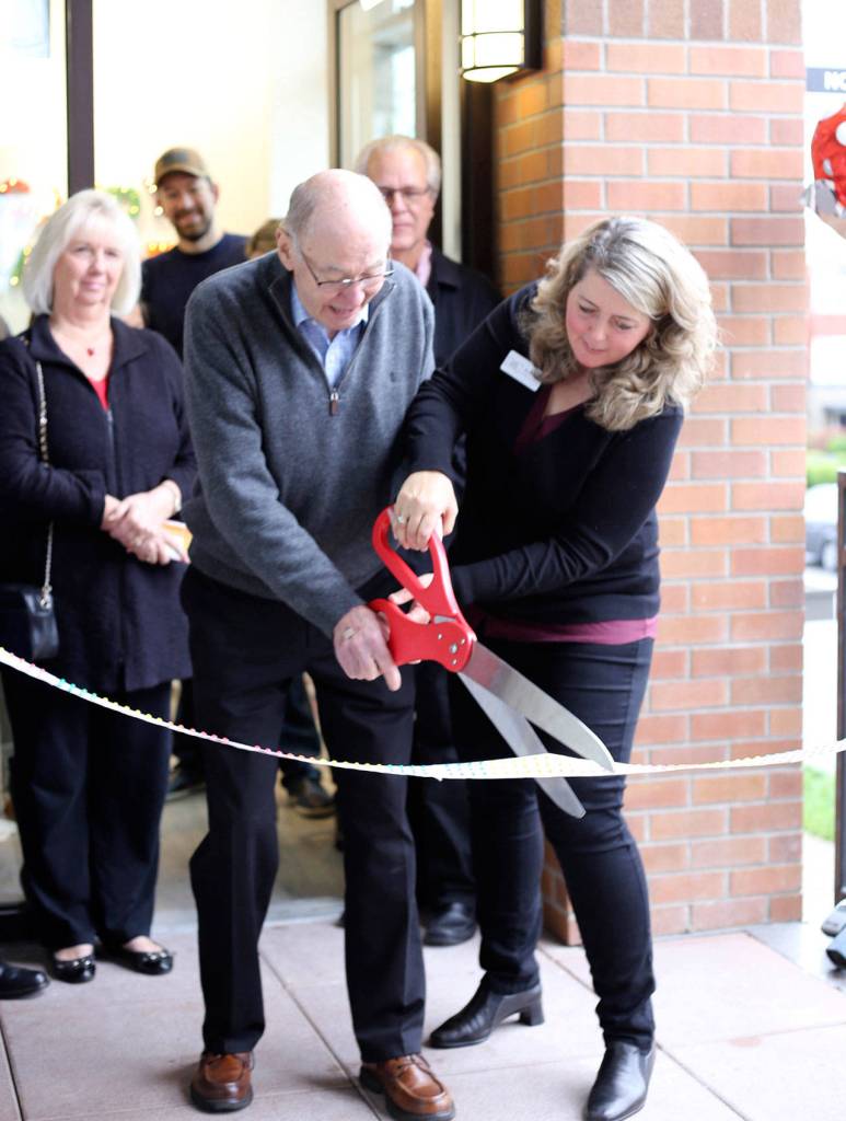 Outgoing Mayor Fred Butler and Candy Mache owner Brenda Zylstra cut the candy ribbon to mark the official opening of the business. Courtesy photo