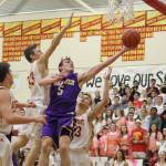 Photo courtesy of Don Borin/Stop Action Photography                                Issaquah Eagles senior guard Cam Roorda (No. 5) maneuvers around the Newport defense for a basket on Jan. 26 at Newport High School in Factoria. Newport defeated Issaquah 56-38.
