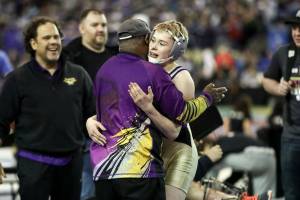 Photo courtesy of Don Borin/Stop Action Photography                                Issaquah Eagles 113-pound wrestler Carson Tanner, right, embraces Issaquah assistant coach Manny Brown after defeating Hanfords Hunter Murphey in the Class 4A 113-pound quarterfinal matchup. Tanner earned sixth place in the Class 4A 113-pound weight division. Brown was named KingCo 4A assistant coach of the year during the 2017-18 season.