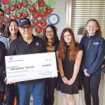 Students and representatives from the The Garage teen cafe accept a $20,000 donation from the Kiwanis Club of Issaquah. Evan Pappas/Staff Photo