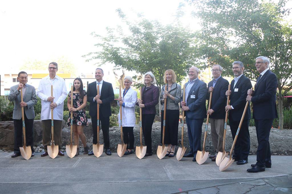 City officials, hospital staff and investors met on May 9 at Overlake Medical Center in Bellevue for a groundbreaking ceremony for a $250 million overhaul and expansion. Members of the groundbreaking party are seen here standing in front a construction site where a new five-story tower will be built. Aaron Kunkler/Staff photo